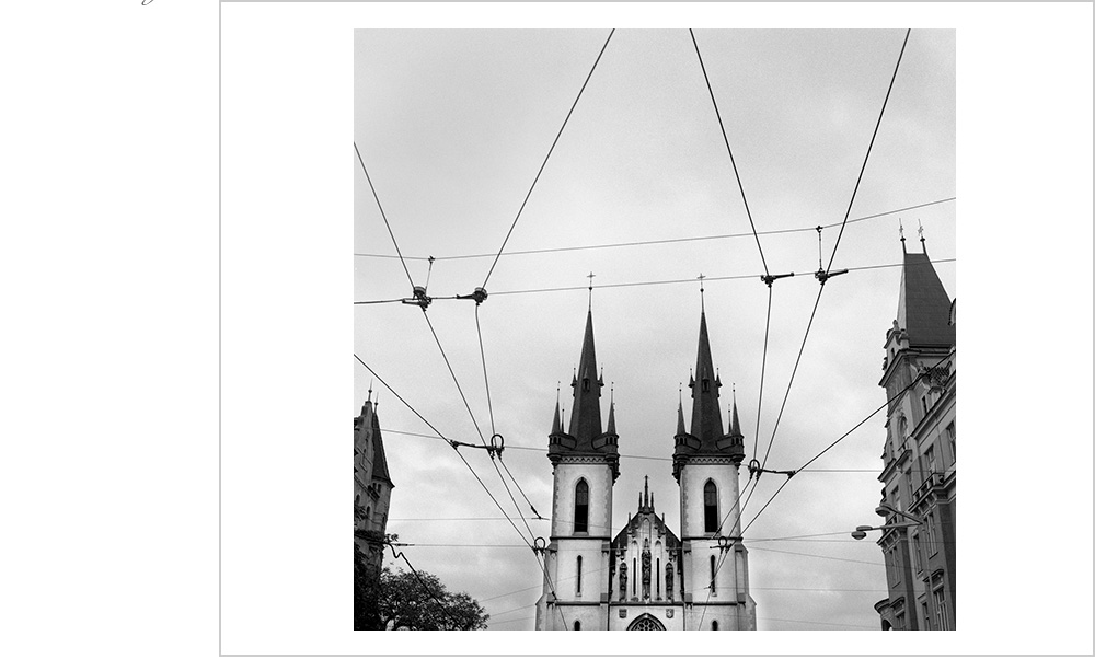 Moody sky and trolley lines frame one of Pragues stunning churches.