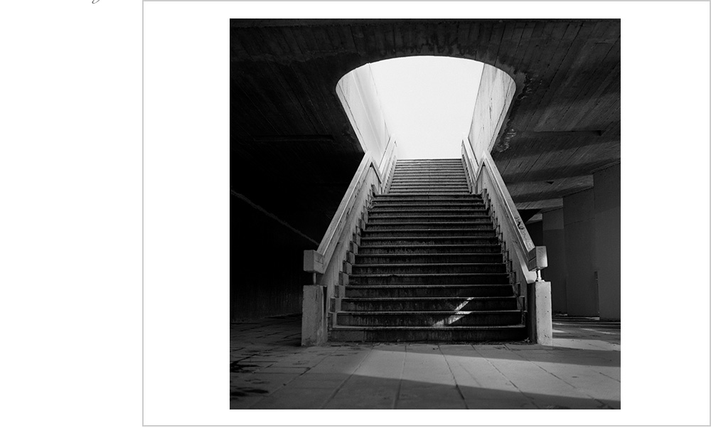 A beam of light cuts through an overcast day in Prague, finding a staircase to highlight.