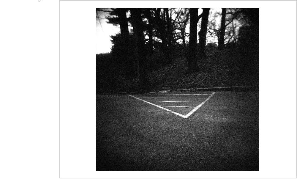A few lines on the ground, some trees on a hill behind. A portal.