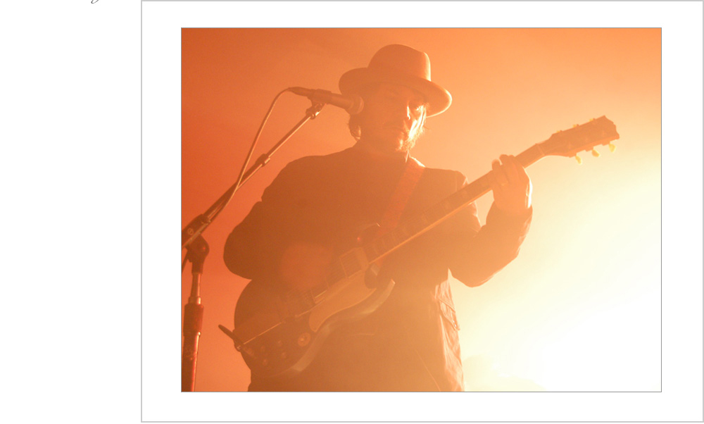 A warm glow surrounds performer and audience alike as Jeff Tweedy from Chicago band, Wilco, perform at the Val Air Ballroom in Des Moines, Iowa.