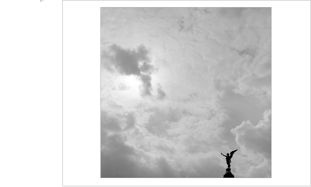 Dramatic clouds reveal the sun coming out to take an offering from a statue of an angel in Prague.