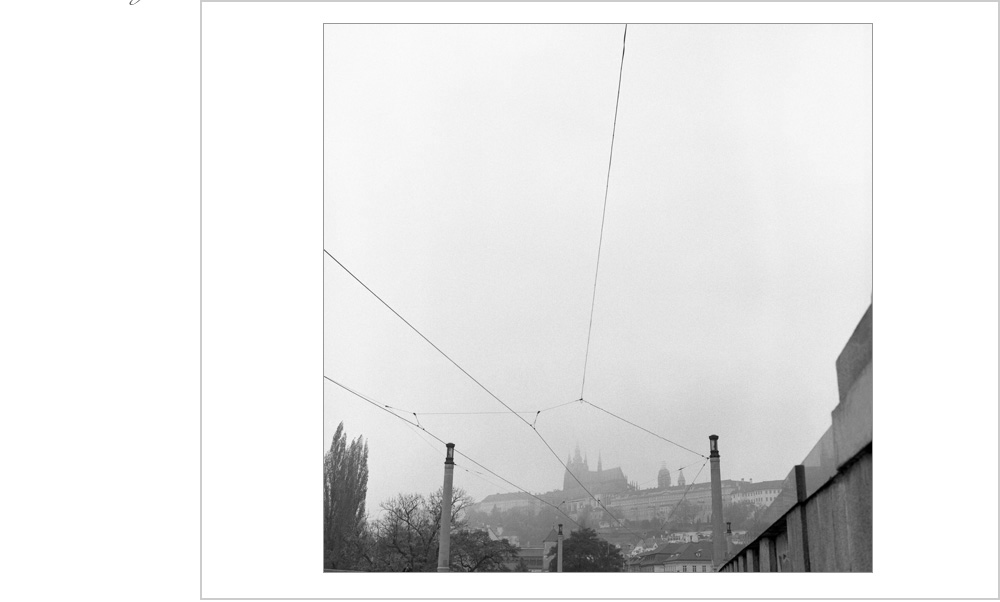 High upon the hill sits the castle of Prague, framed majestically by the wires on mankind. There!