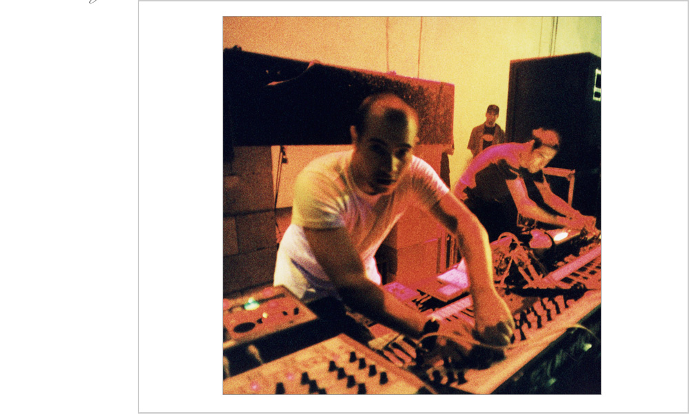 Two DJ's tweak the sound from behind a bank of electronic instruments at this underground rave in Oakland, Ca, 1999.