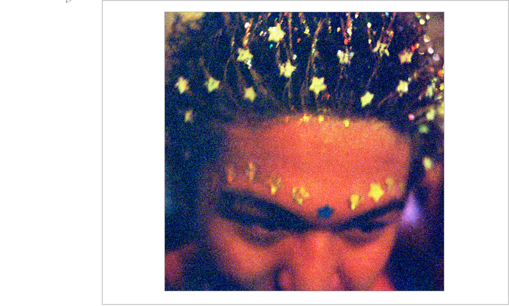 A dancer at an 1999 underground rave in Oakland, California adorned in glow in the dark stars.
