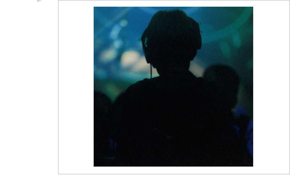 A silhouetted DJ takes a quiet moment right before the drop hits at an underground rave in Oakland, California in 1999.